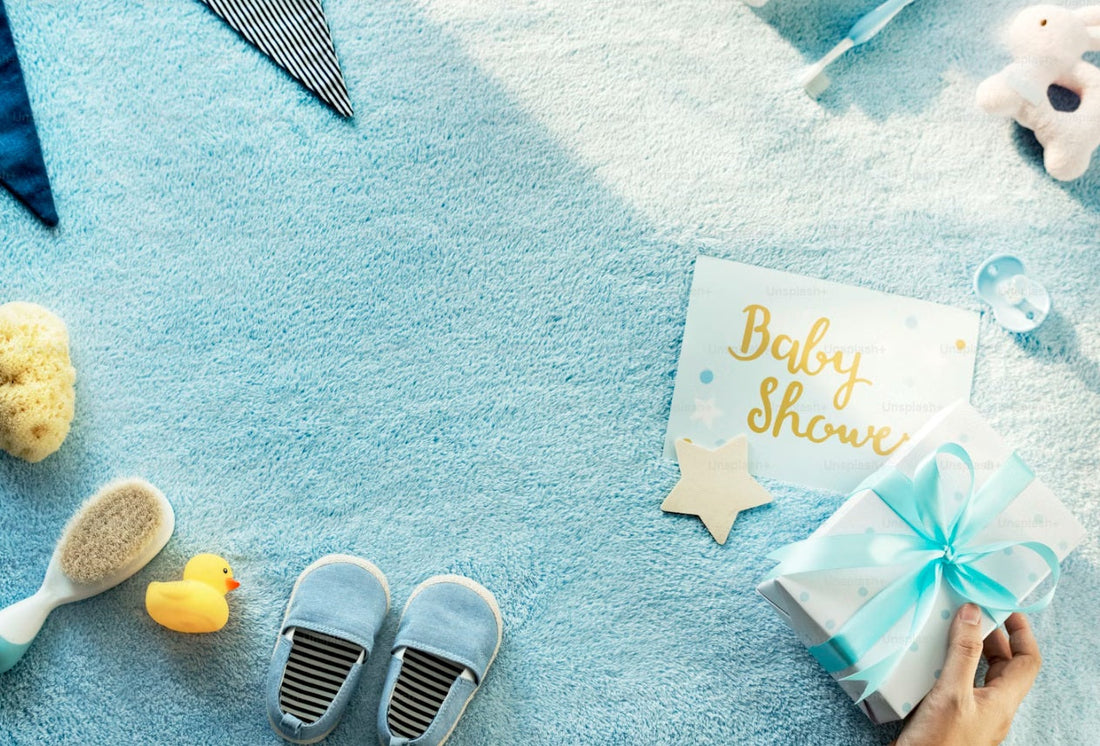 Baby shower preparation essentials including baby shoes, wrapped gift, and soft blue decorations for a home celebration