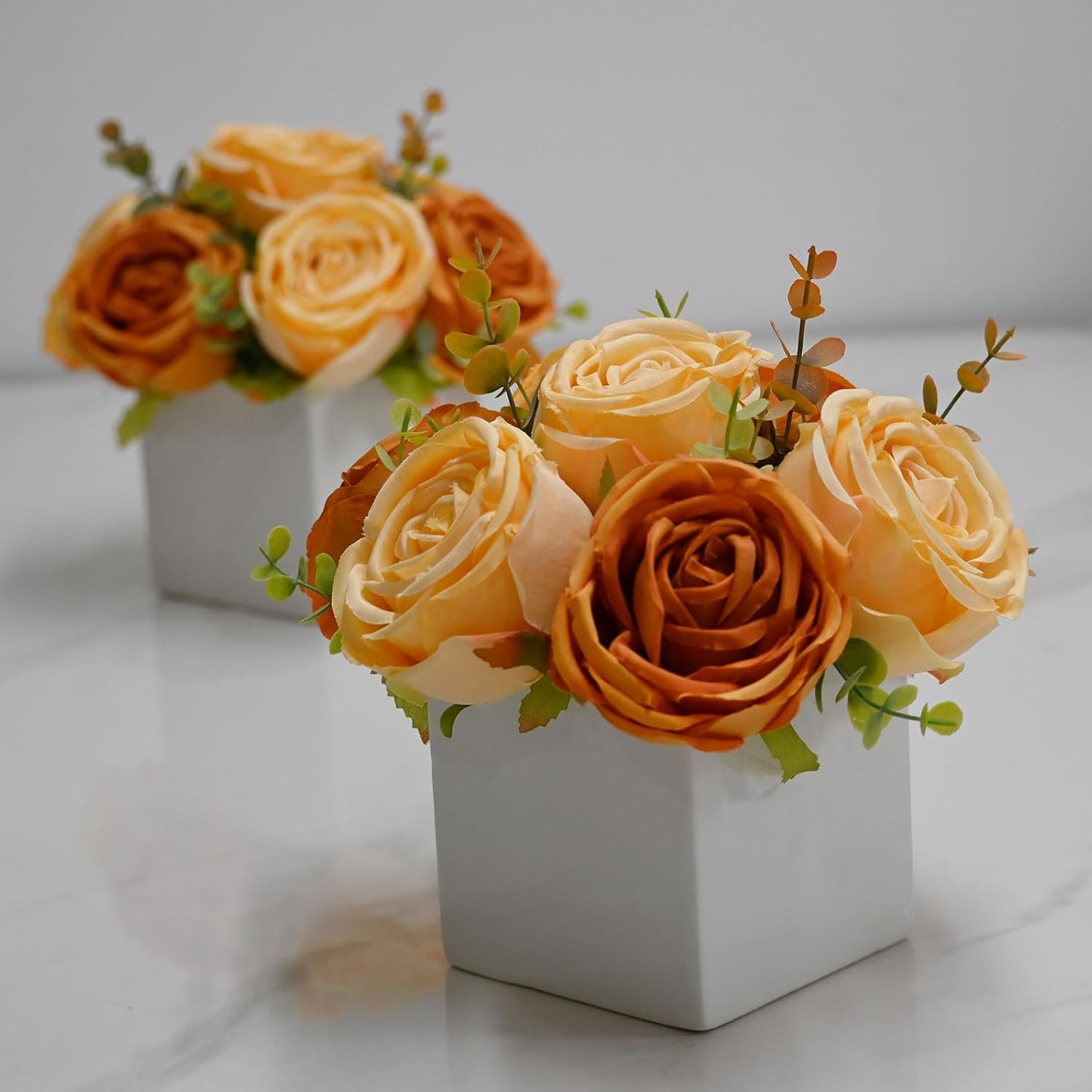 LADADA Artificial Roses in White Ceramic Vase, Orange and Cream Fake Flowers with Eucalyptus Stems, Faux Floral Arrangement for Home Decor, Table Centerpiece for Dining Table, Kitchen, Office